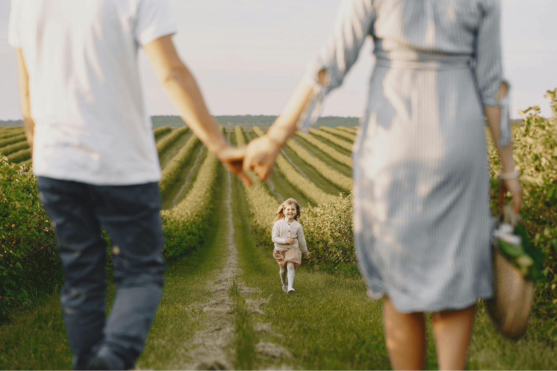 happy-couple-watching-child-in-field-pennington-family-law